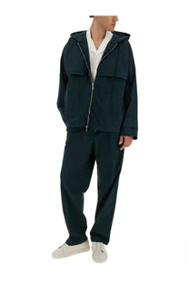 Dark green hooded jacket with central zipper and two large flap pockets paired with helmut lang men’s green zoot cargo pants