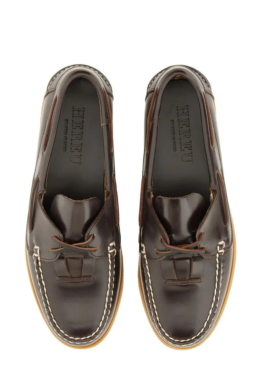 Hereu women’s boat moccasin in dark brown leather with tan stitching and light-colored soles
