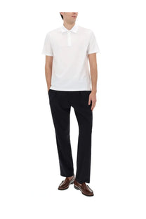 White short-sleeved polo shirt with classic collar and button placket paired with herno men’s blue wool blend pants