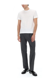 White cotton crew neck t-shirt with short sleeves paired with herno men’s grey wool blend tailored pants