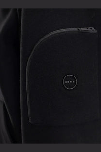 Hevò men’s grottaverde black virgin wool blend coat pocket with circular button featuring four dots and matching zipper