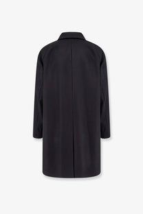 Back side of hevò men’s loco virgin wool coat in black with a sleek minimalist design and subtle vertical seam