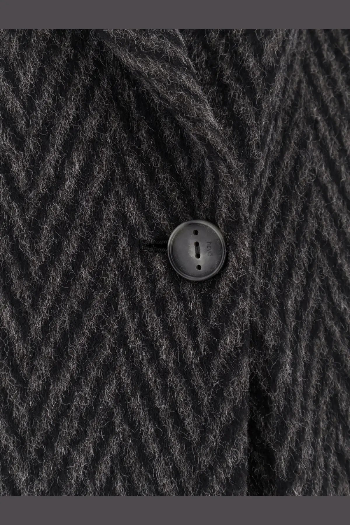 Black circular matte button on hevò men’s santa cesarea wool blend coat made of dark gray herringbone fabric