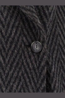 Black circular matte button on hevò men’s santa cesarea wool blend coat made of dark gray herringbone fabric
