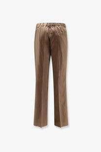 Brown satin-like hevò men’s torre chianca linen and viscose trousers with elastic waistband and subtle back pocket shown from back
