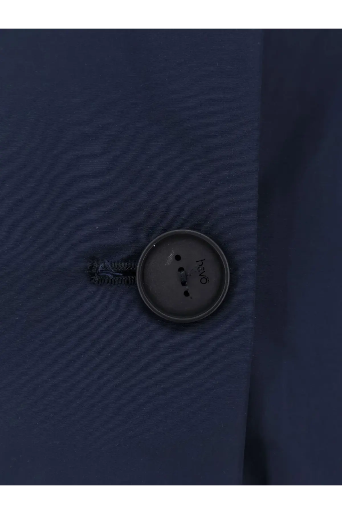 Dark gray button with hvo engraving on navy blue cotton blend fabric of hevò womens cala paradiso raincoat blue