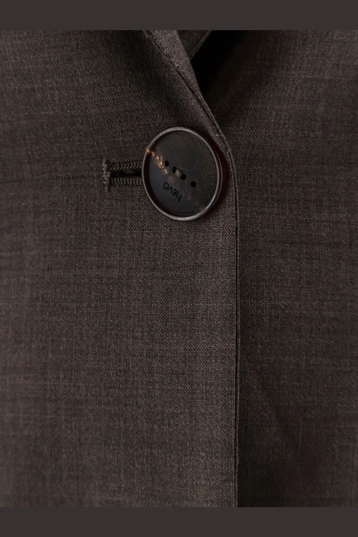 Dark gray button with subtle sheen engraved with hugo on hevò women’s frigole beige virgin sheeps wool suit