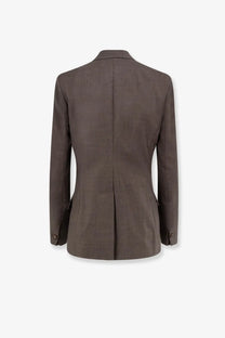 A tailored beige blazer with subtle textured weave and classic notched lapel made from frigole virgin sheeps wool