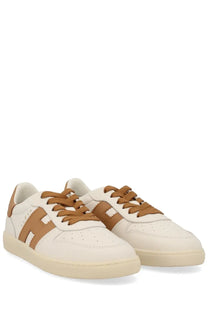 Cream-colored leather Hogan women’s sneaker beige with tan laces and matching h-shaped logo on the side