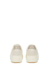 Cream-colored leather platform sneakers with glittery metallic heel tab shown from the back by hogan women