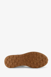 Tan rubber sole with square tread blocks and volk brand name on hogan womens beige nylon and suede sneakers