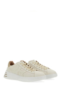 Cream-colored suede hogan women’s rebel sneakers with white rubber sole and beige laces for casual wear