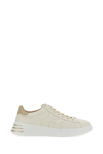 Cream-colored suede hogan women’s rebel sneaker with white rubber sole and gold-tone metallic stripes on heel back view