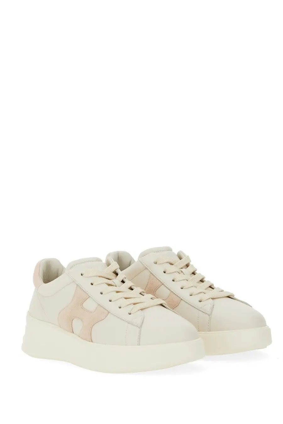Cream-colored Hogan women’s Rebel sneaker with soft suede finish and blush pink logo panels