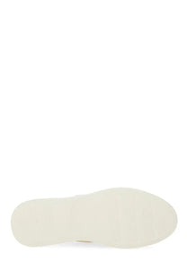 Cream-colored rubber sole with smooth textured surface and rounded heel on hogan women’s rebel sneaker white back view