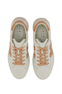 Cream-colored Hogan women’s Rebel sneakers with tan leather accents and laces for casual wear