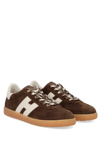Hogan women’s sneaker cool brown featuring brown suede, bold white h logo, cream laces, and gum rubber soles
