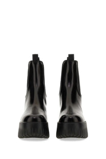 Hogan women’s stripe chelsea boot black with black patent leather and chunky textured rubber sole front view