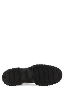 Black rubber sole with chunky textured tread on the back of hogan women’s stripe chelsea boot black