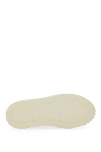 Cream-colored rubber sole with textured wavy edges on hogan women’s stripes sneaker white back side view
