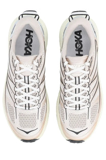 Pair of hoka one one mafate beige unisex running shoes with breathable mesh uppers and bold geometric detailing