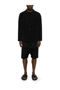 Black pleated Homme Plisse Issey Miyake men’s blazer with structured collar and three buttons in sleek design