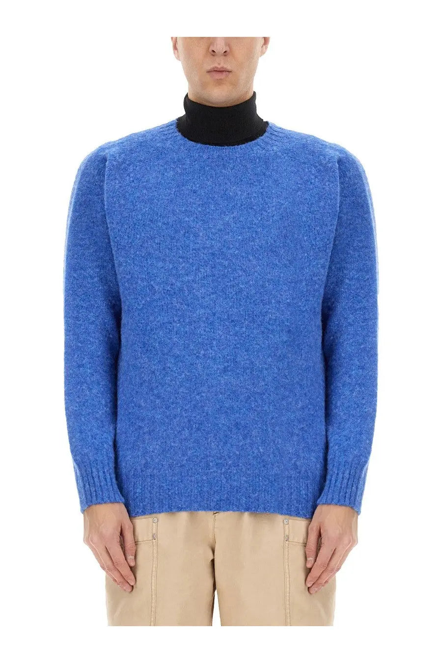 Howlin men’s wool jersey blue heathered wool sweater with ribbed cuffs and hem worn over black turtleneck