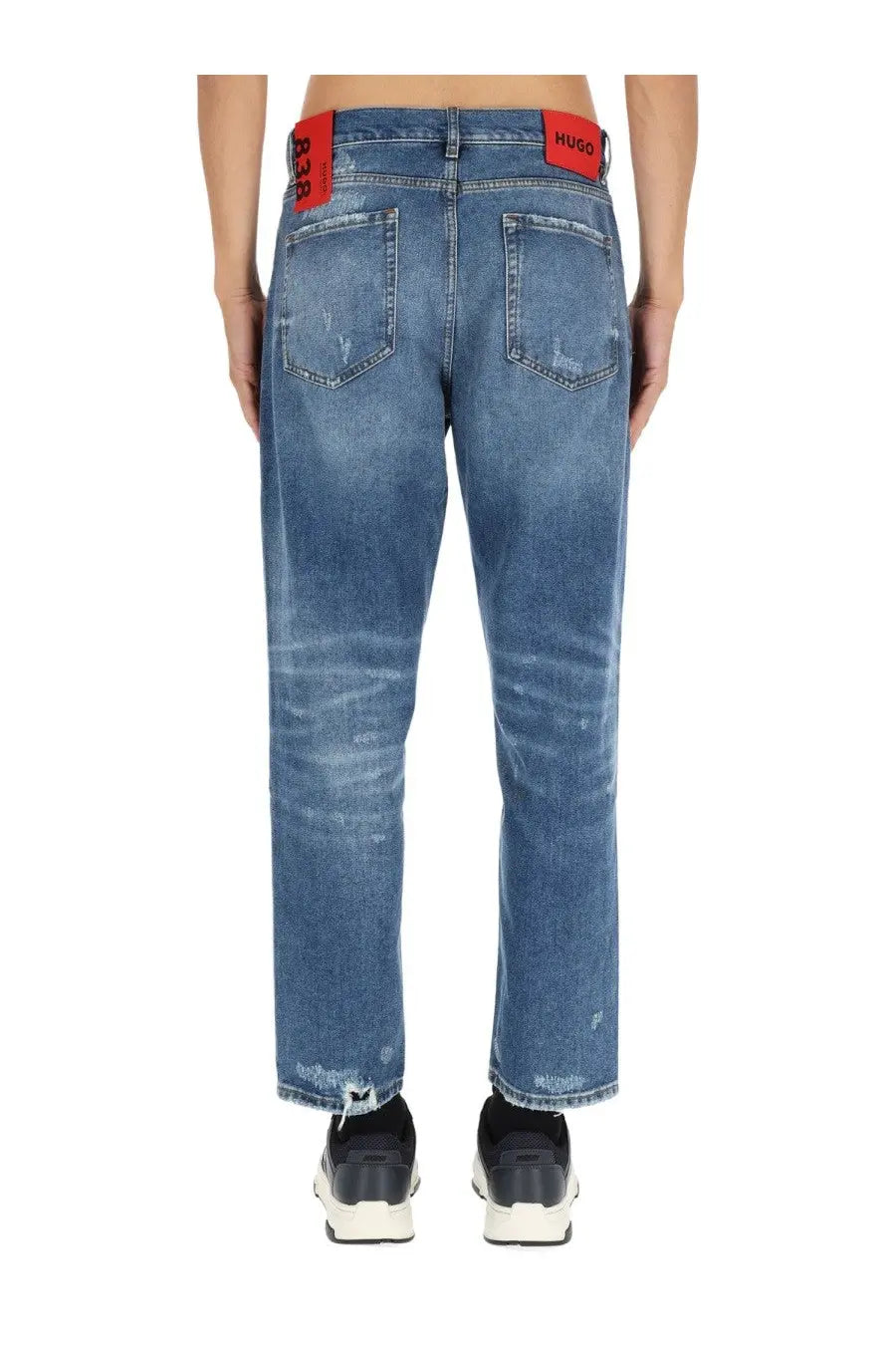 Hugo boss men’s blue denim jeans with faded wash and distressed cuffs and back pockets with red branded patches