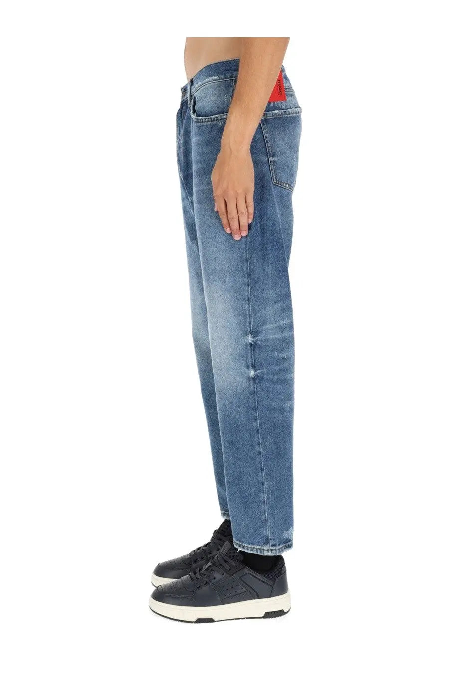 Medium-wash blue denim hugo boss men’s jeans with faded distressed look and subtle whiskering along the legs