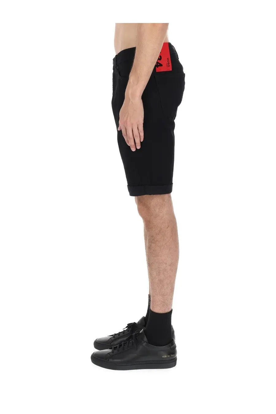 Hugo boss men’s black denim shorts with red brand tag on waistband showing front side details