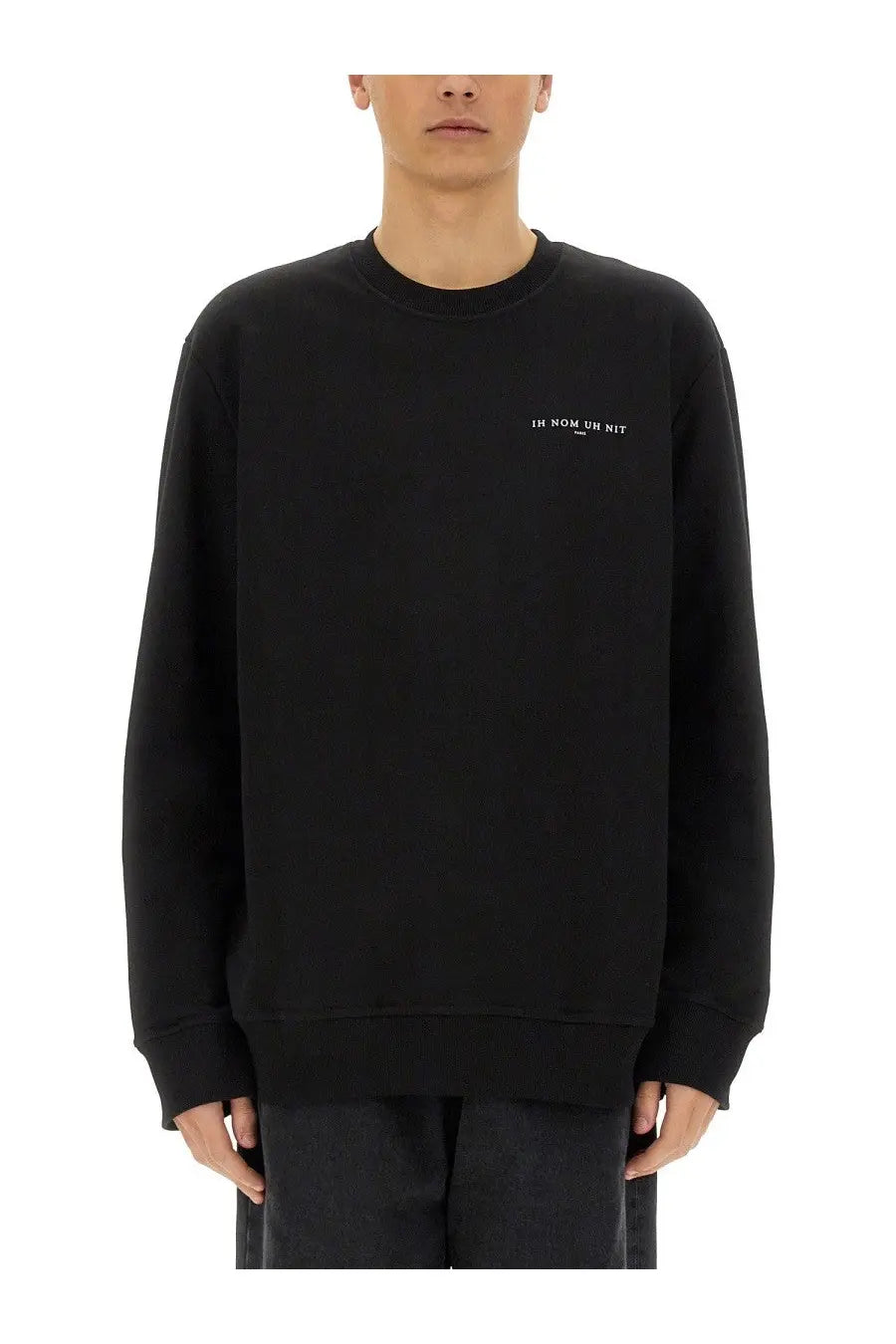 Black ih nom uh nit crewneck sweatshirt with subtle white embroidered crown mask print on left chest