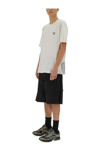 Ih nom uh nit men’s white cotton t shirt with love all print in black and sheer mesh panel along the side seam
