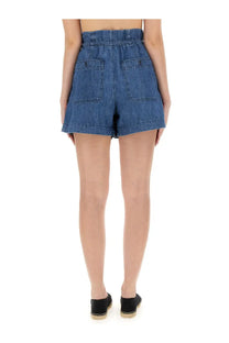 Back view of isabel marant étoile women’s high-waisted medium blue denim shorts with elastic waistband and two pockets