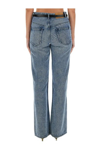 Isabel Marant women’s blue denim flare jeans with black belt and brown leather tab shown from the back side