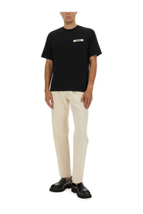 Jacquemus men’s black short-sleeved t-shirt with white gros grain rectangular label on the chest