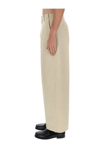 Jacquemus men’s beige wide-leg trousers with clean tailored fit and subtle front seam detailing