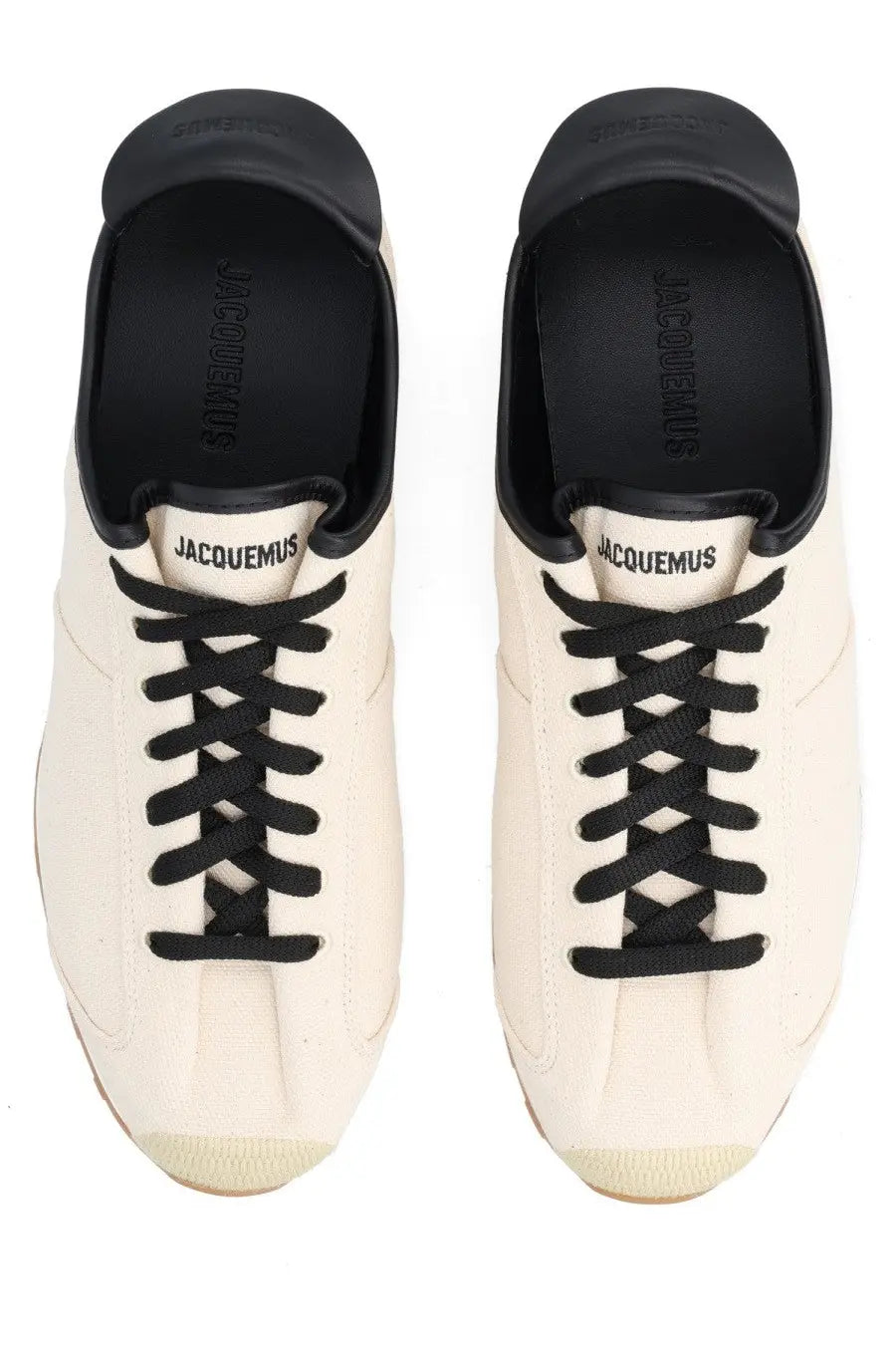 Cream-colored jacquemus men sneaker les tennis white canvas with black laces and rubber toe caps visible from the front