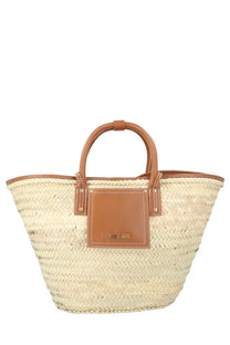 Beige woven straw tote bag with tan leather handles and jacquemus brand patch women’s bag soli beige