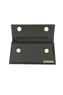 Jacquemus women’s borsa le chiquito long black leather clutch with gold-tone magnetic clasps and embossed brand name