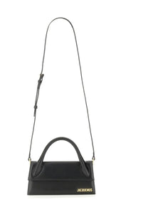 Black leather jacquemus borsa le chiquito long handbag with gold-tone branding on the front