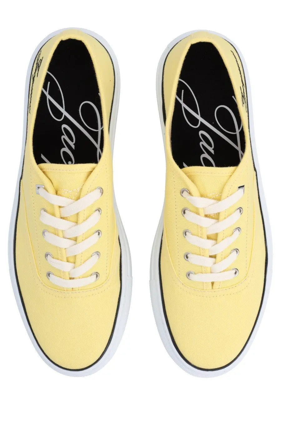 Pair of jacquemus women’s pale yellow canvas sneakers with white laces and black trim for casual wear
