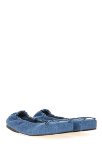 Jacquemus women’s square dancer blue denim ballet flats with soft stretchy upper and black soles shown from back