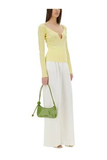 A sleek glossy lime green jacquemus women’s the top praluce yellow handbag with a curved silhouette and matching handle