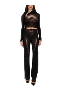 Jean paul gaultier women’s brown pants paired with a shimmering black sheer two-piece set with metallic sheen