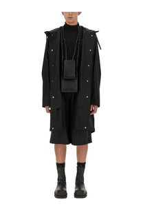 Black rectangular crossbody bag with chain strap and minimalist design paired with jil sander mens parka black