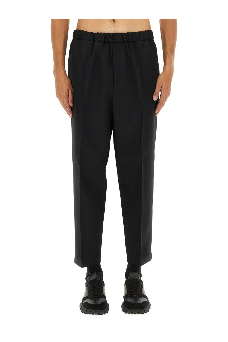 Jil Sander men’s tapered black trousers with elastic waistband and sleek modern cut in smooth fabric