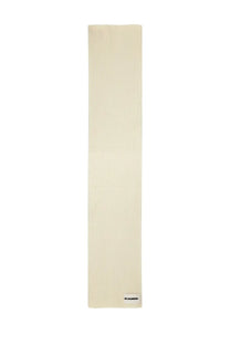 Cream-colored ribbed knit wool scarf by jil sander featuring minimalist design and subtle texture in beige