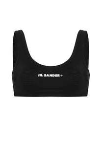 Black jil sander sports bra with white logo across chest in a women’s bikini top for activewear and swimwear use