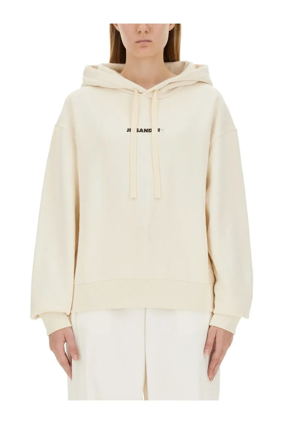 Cream-colored jil sander women’s oversized hoodie with black logo and matching drawstrings in soft cotton blend