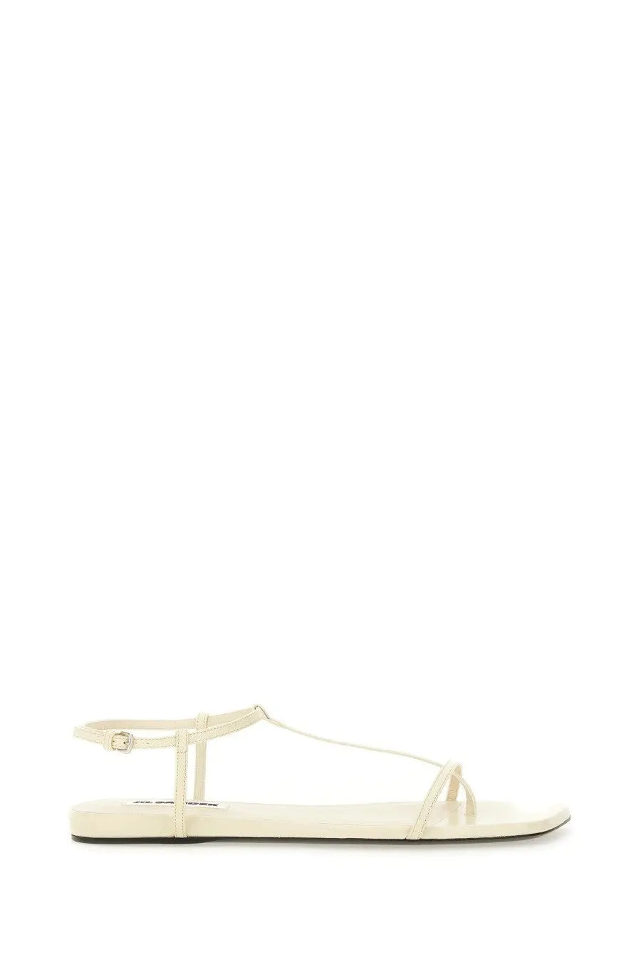 Cream-colored jil sander women’s leather sandal with thin straps and flat sole for minimalist style
